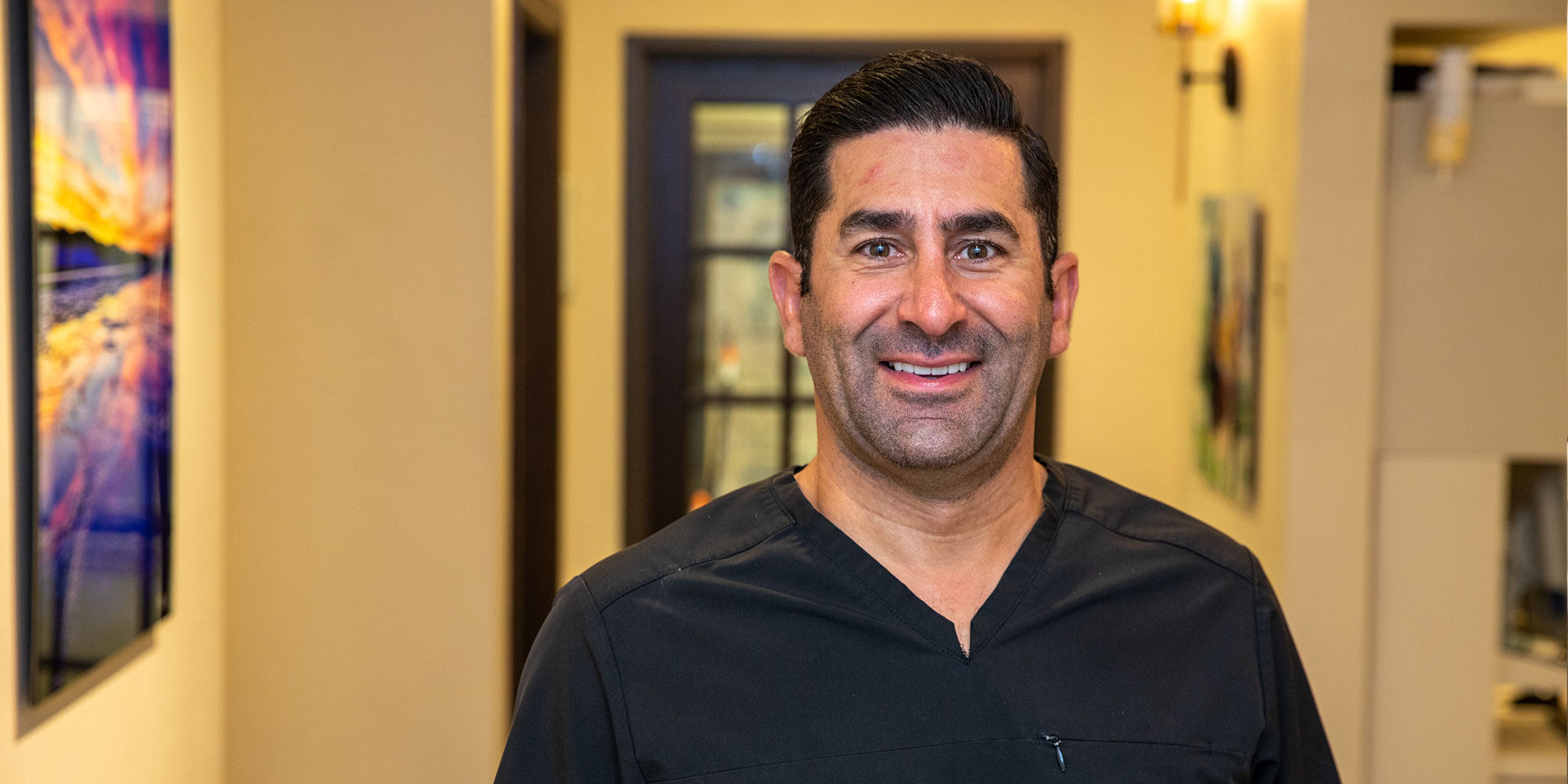 headshot of doctor within in the dental center
