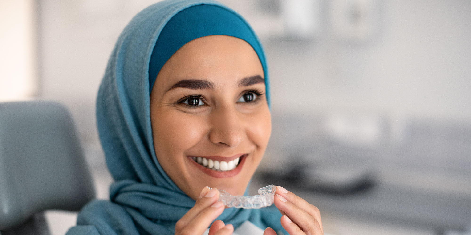 dental Invisalign patient trying their aligner on for the first time within the denta