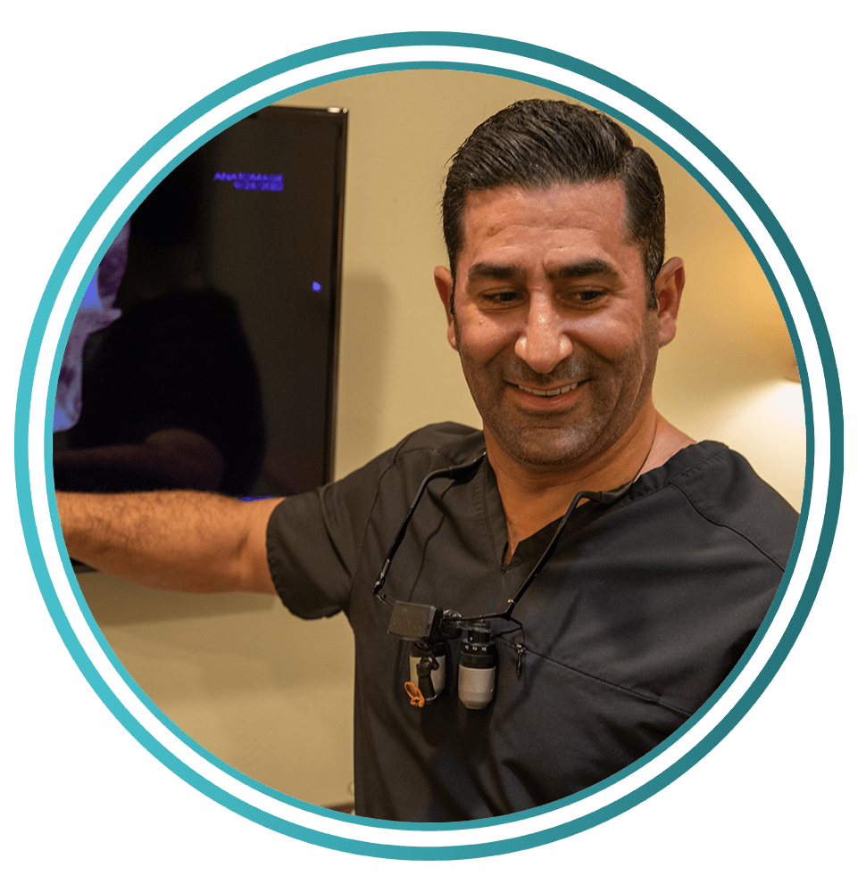 doctor with frame and showing off dental treatment information with patient