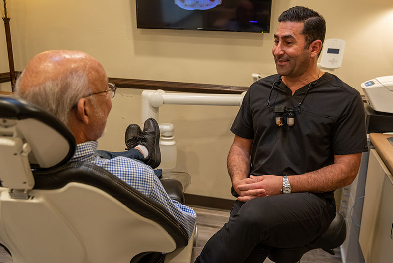 Doctor going over dental treatment information with patient in the dental practice